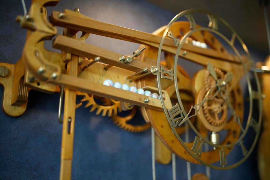 image of a clock mechanism showing gears made of brass. that are good for low friction, long-lasting for small mechanism. 