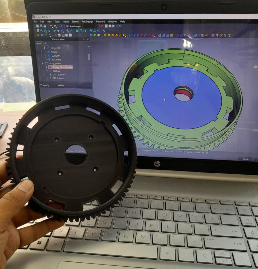 this the image where a real 3d printed part showing side by side it cad indign in laptop.